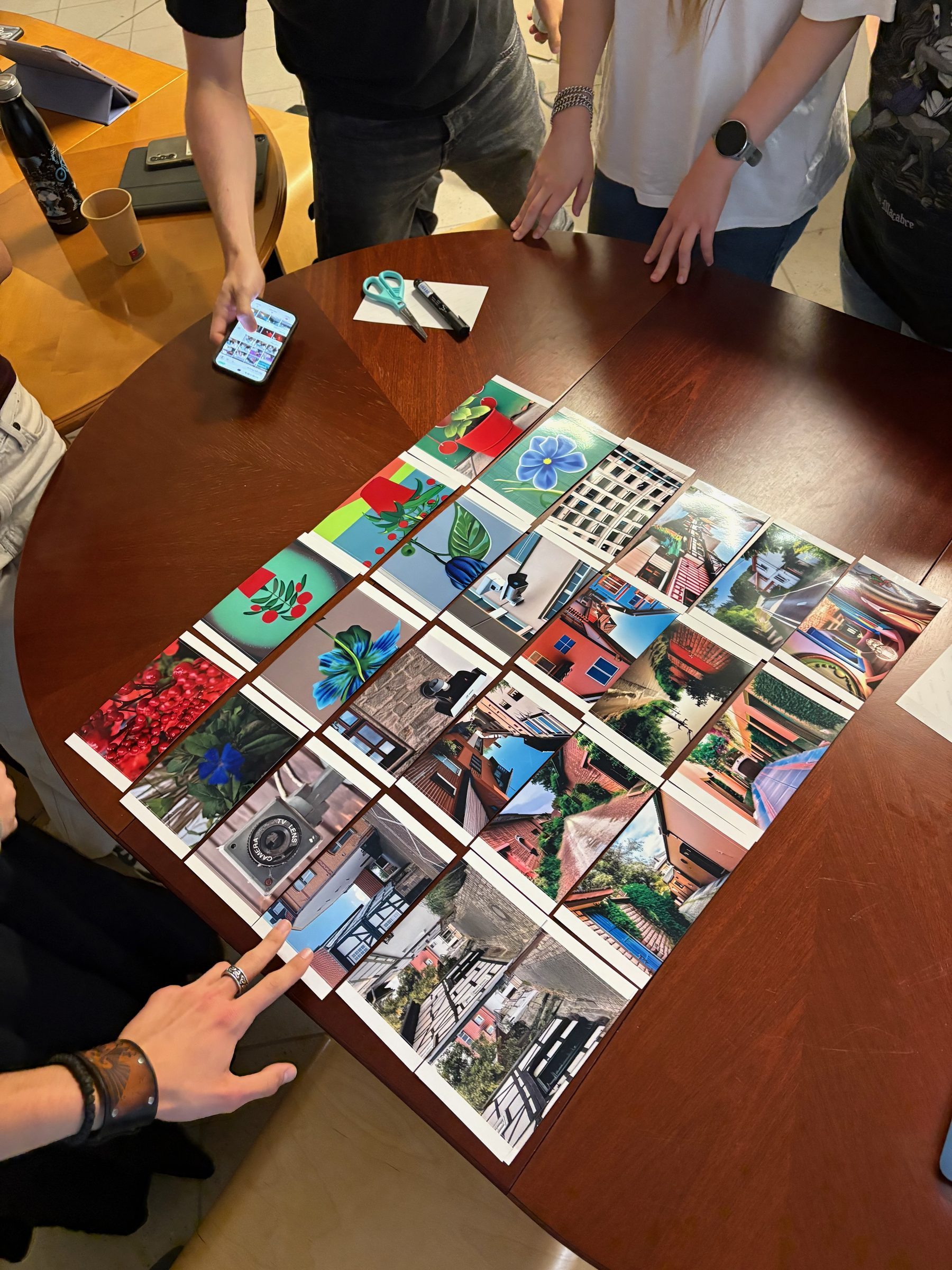 Participants around a table arranging printed image chains